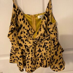 Gold and black top cross tie in front. adjusted strap zipper in the back